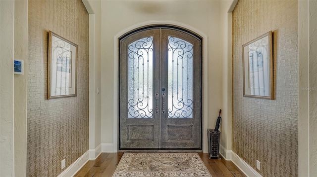 entrance foyer with french doors and hardwood / wood-style floors