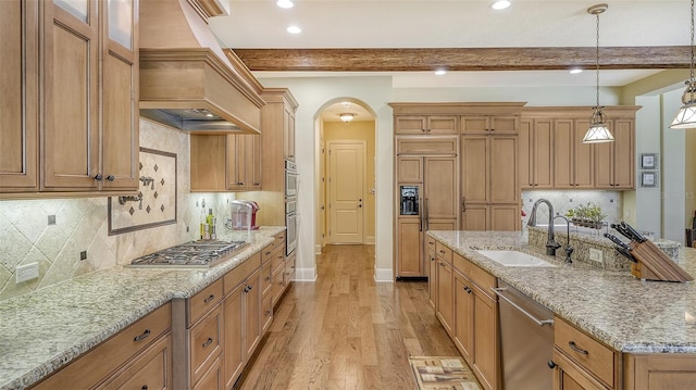 kitchen featuring sink, hanging light fixtures, beamed ceiling, light hardwood / wood-style floors, and custom exhaust hood