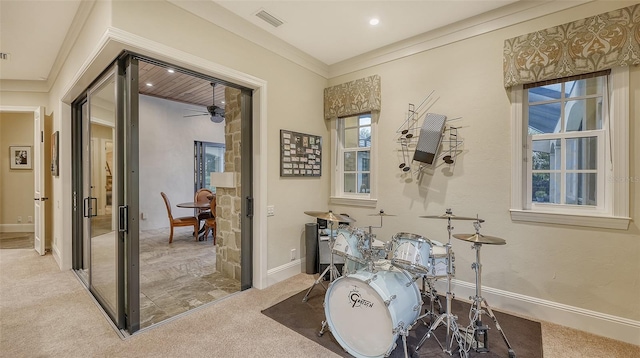 interior space with ceiling fan and ornamental molding