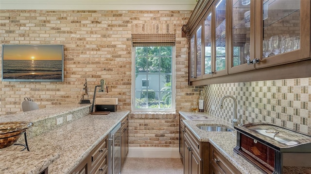 kitchen featuring light stone counters, sink, and a healthy amount of sunlight