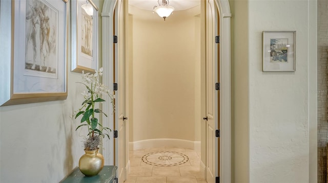 hall with light tile patterned floors