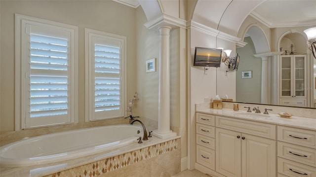 bathroom with decorative columns, vanity, a relaxing tiled tub, and ornamental molding