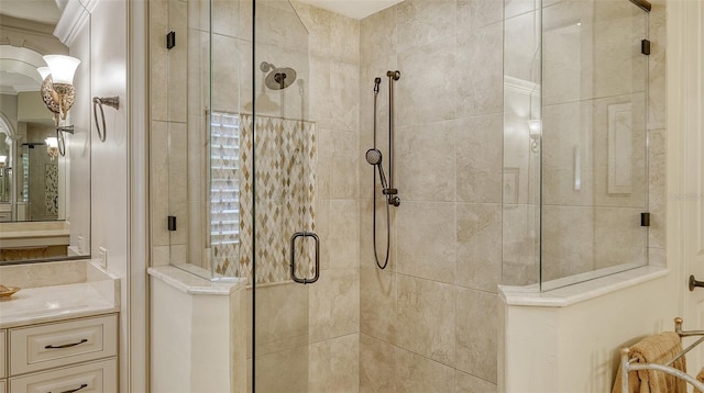 bathroom with vanity and a shower with door