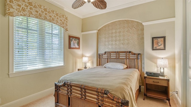 carpeted bedroom with ceiling fan and ornamental molding