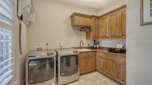 clothes washing area featuring cabinets, independent washer and dryer, sink, and light tile patterned floors