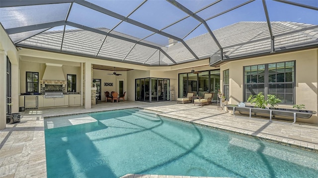 rear view of house featuring area for grilling, ceiling fan, a patio, and glass enclosure