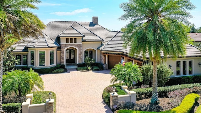 view of front of property featuring a garage and french doors