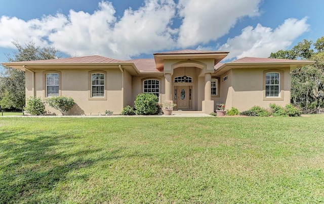 mediterranean / spanish house with a front yard