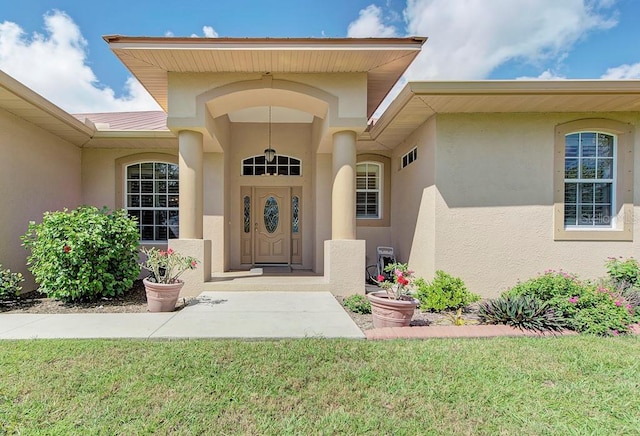 doorway to property with a yard