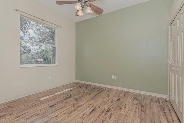 empty room with light hardwood / wood-style flooring and ceiling fan