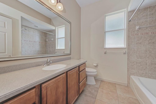 full bathroom featuring toilet, vanity, tile patterned floors, and a wealth of natural light