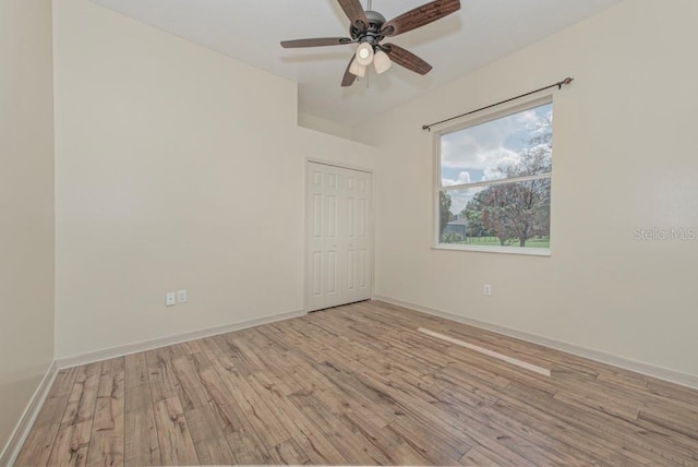 empty room featuring ceiling fan and light hardwood / wood-style flooring