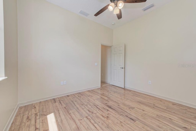 unfurnished room with a high ceiling, light wood-type flooring, and ceiling fan