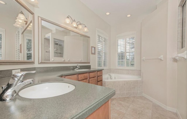 bathroom with vanity, a relaxing tiled tub, and tile patterned floors