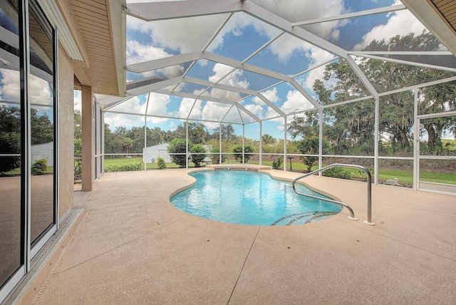 view of swimming pool with a patio area and a lanai