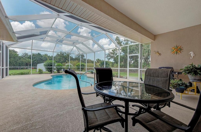 view of swimming pool featuring a patio and glass enclosure