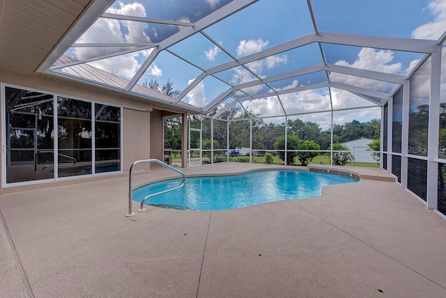 view of swimming pool with a patio and a lanai