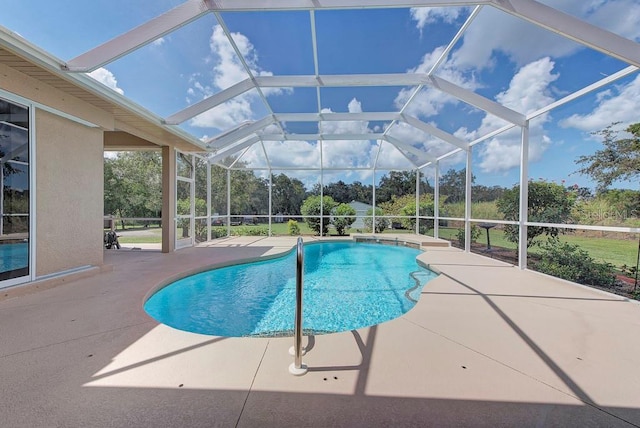 view of pool featuring a patio and glass enclosure