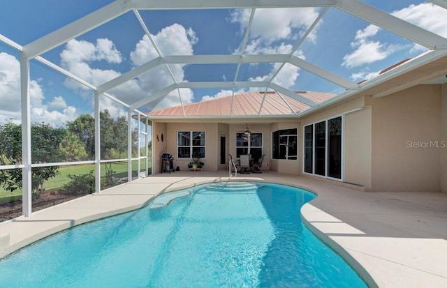 view of swimming pool featuring area for grilling, a patio area, glass enclosure, and ceiling fan