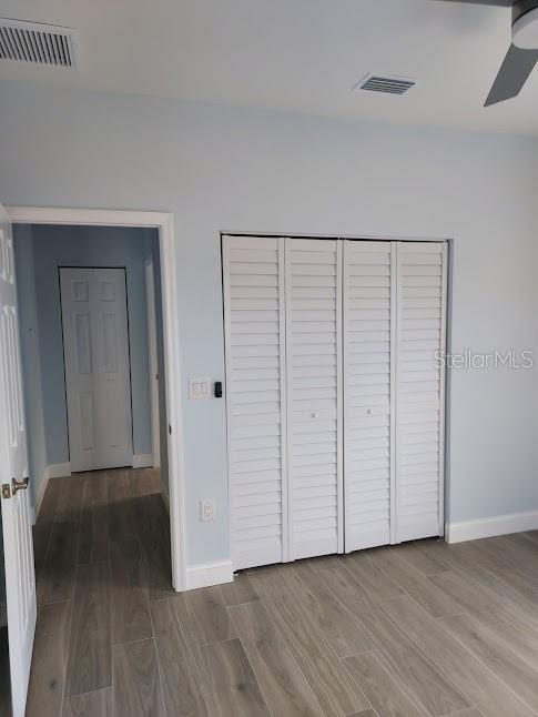 unfurnished bedroom with hardwood / wood-style floors and ceiling fan