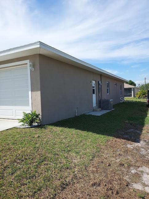 view of side of property with a garage and a yard