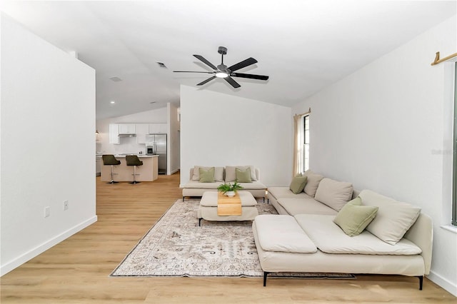 living room with lofted ceiling, light hardwood / wood-style flooring, and ceiling fan