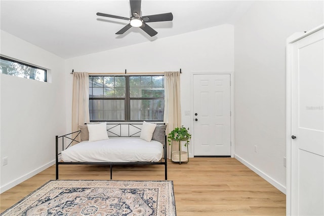 bedroom featuring ceiling fan, lofted ceiling, and light hardwood / wood-style floors