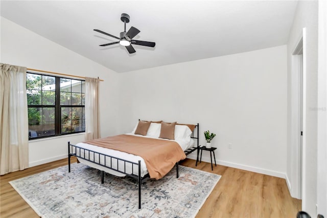 bedroom with lofted ceiling, ceiling fan, and light hardwood / wood-style floors