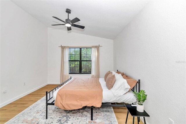 bedroom featuring vaulted ceiling, hardwood / wood-style floors, and ceiling fan