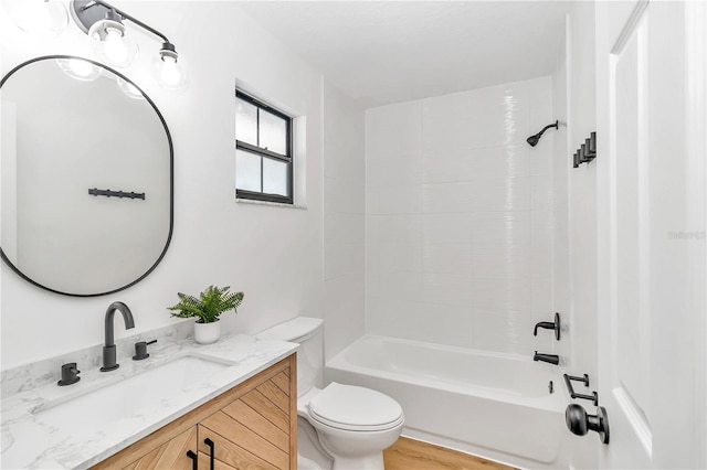 full bathroom with bathtub / shower combination, hardwood / wood-style flooring, vanity, and toilet