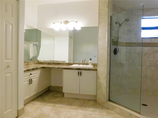 bathroom featuring an enclosed shower, vanity, and tile patterned floors