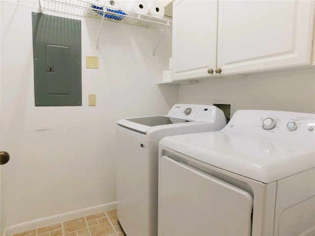 clothes washing area featuring electric panel, washing machine and dryer, and cabinets