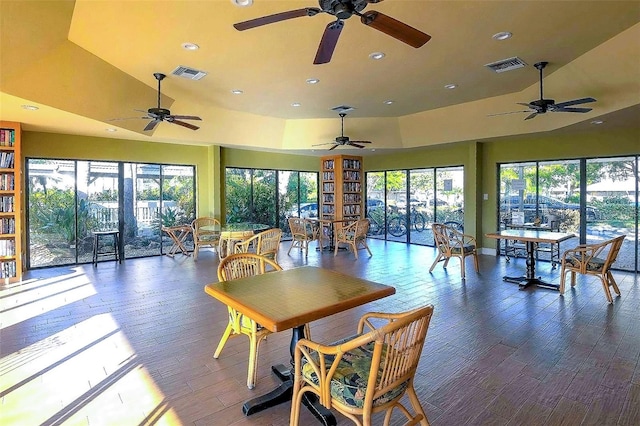 dining space with a towering ceiling and dark wood-type flooring