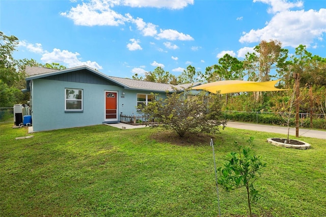 back of house featuring a yard