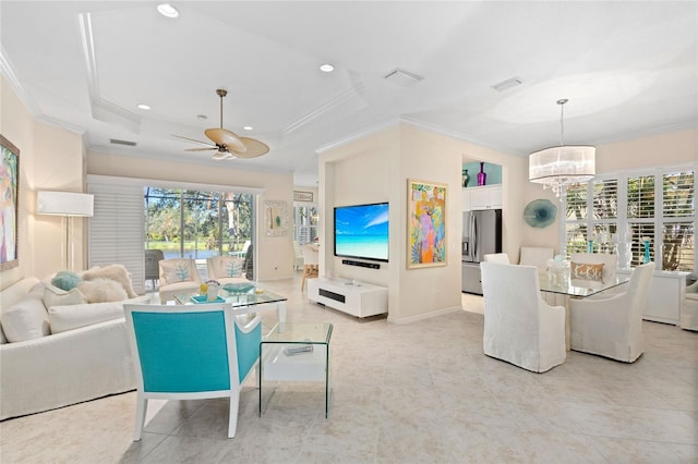 living room with ceiling fan with notable chandelier and crown molding