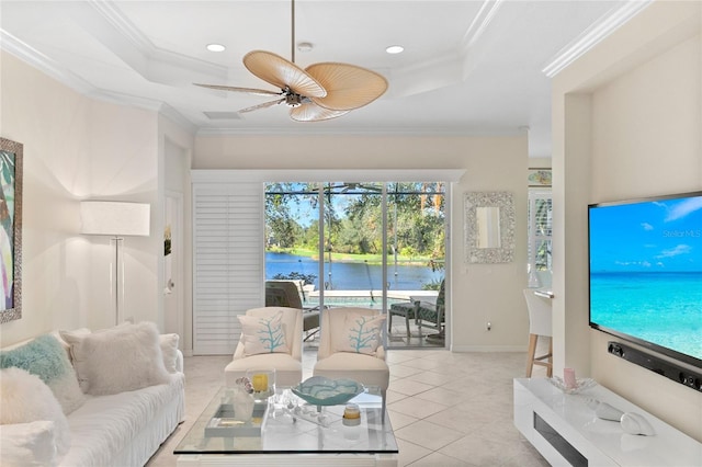 tiled living room with a raised ceiling, ceiling fan, and crown molding