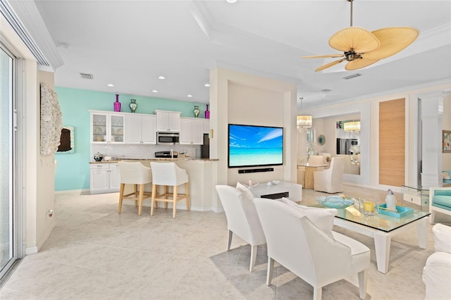 dining room featuring ceiling fan, plenty of natural light, light tile patterned floors, and ornamental molding