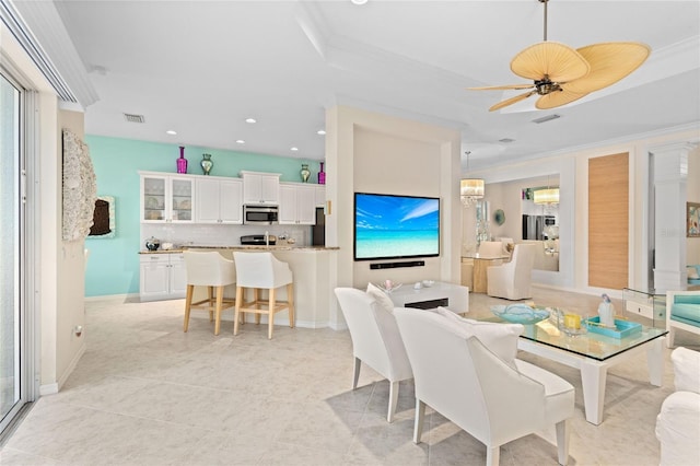 12121 Thornhill Ct, Lakewood Ranch, FL 34202 - living room featuring a tray ceiling, recessed lighting, ornamental molding, a ceiling fan, and light tile patterned floors