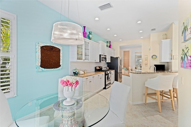 dining area featuring a healthy amount of sunlight and sink