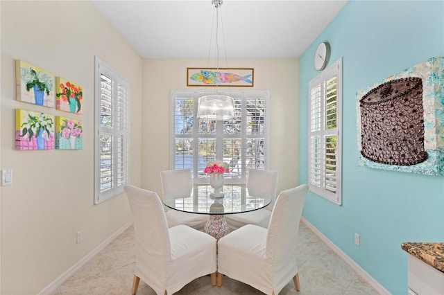 dining space with a notable chandelier and light tile patterned floors