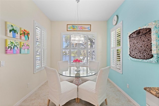 12121 Thornhill Ct, Lakewood Ranch, FL 34202 - dining space with tile patterned floors, a chandelier, and baseboards