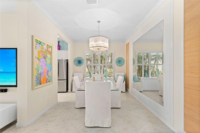 dining room with ornamental molding and a chandelier