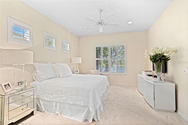 bedroom featuring ceiling fan and light colored carpet