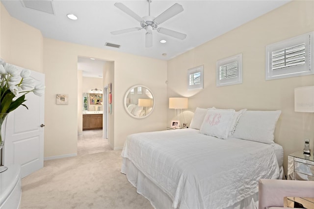 bedroom with connected bathroom, ceiling fan, and light colored carpet