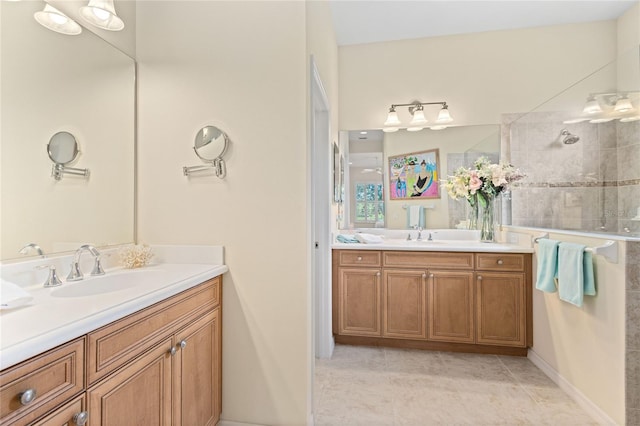 bathroom featuring a tile shower, tile patterned floors, and vanity