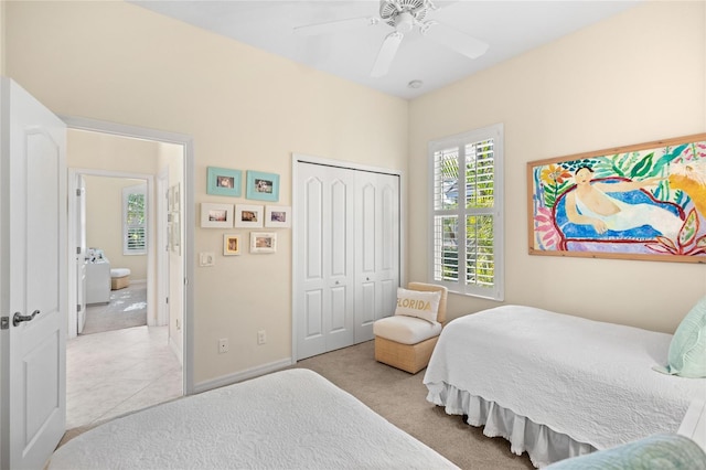 bedroom featuring ceiling fan, light colored carpet, and a closet