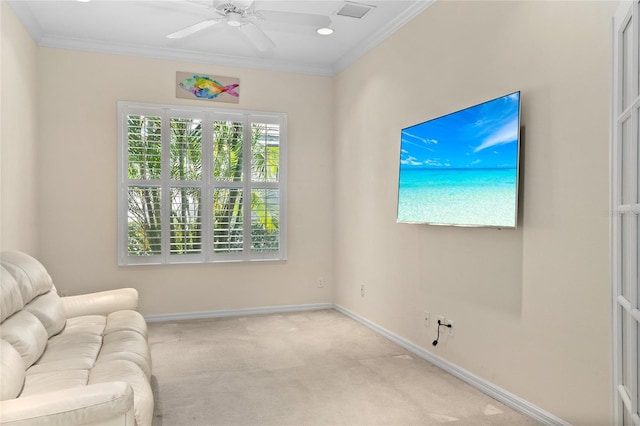 sitting room featuring ceiling fan, light colored carpet, and crown molding