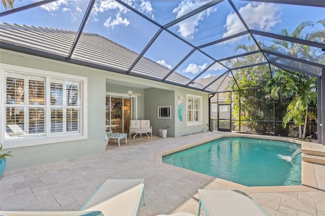 view of pool featuring a lanai, pool water feature, ceiling fan, and a patio area