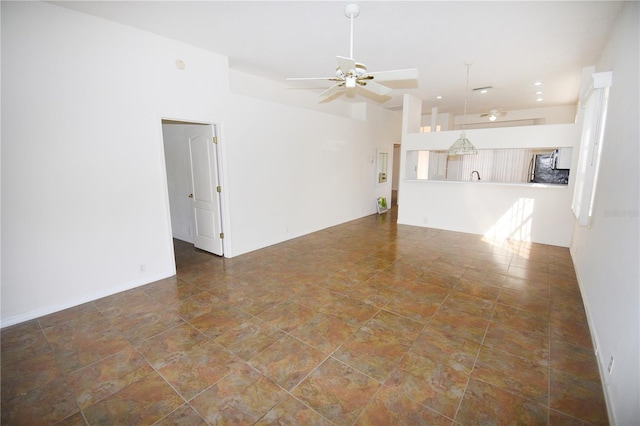 unfurnished living room featuring ceiling fan