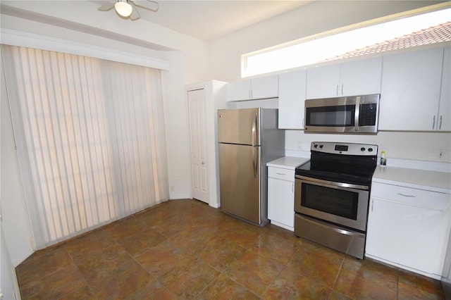 kitchen featuring appliances with stainless steel finishes, white cabinetry, and ceiling fan